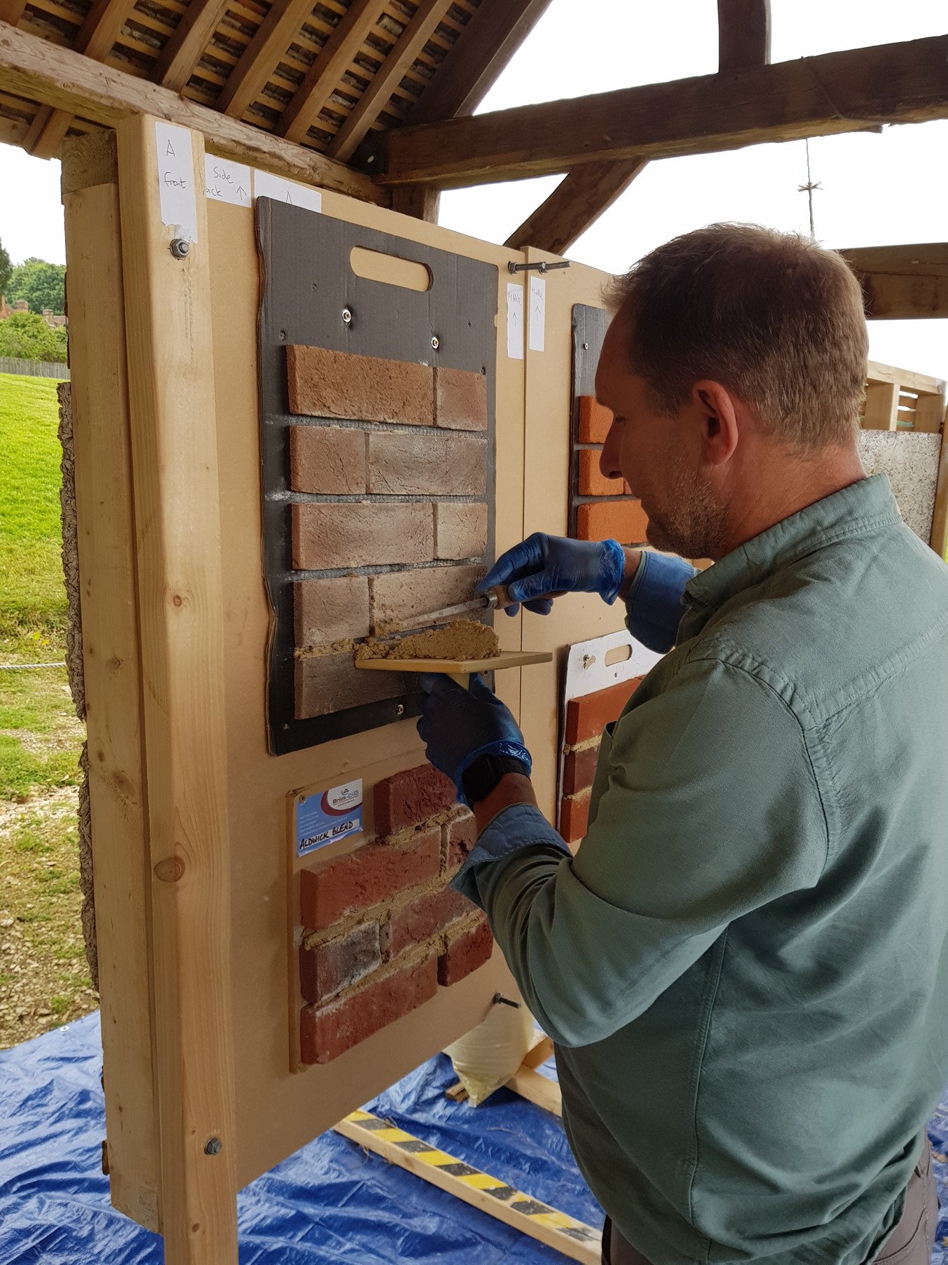 A man works on bricks as part of a course