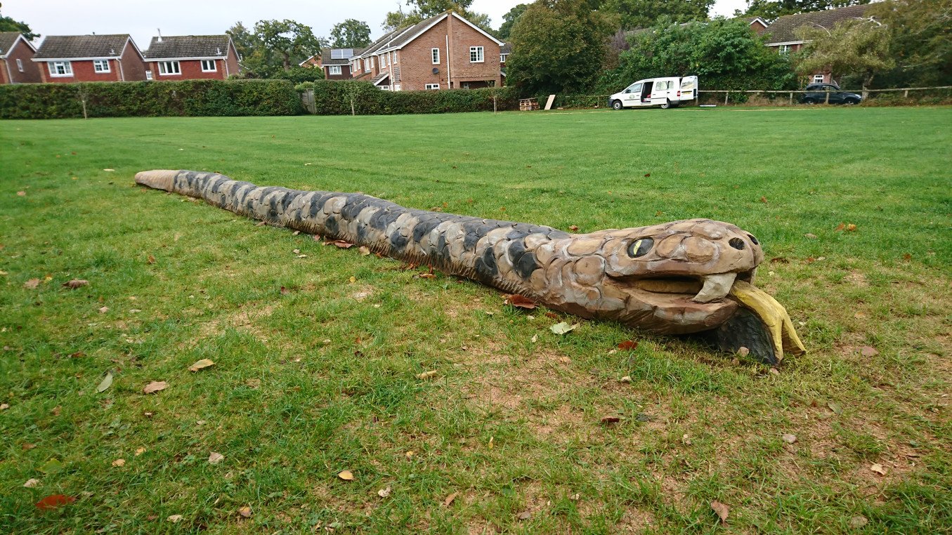 A large wooden carved snake