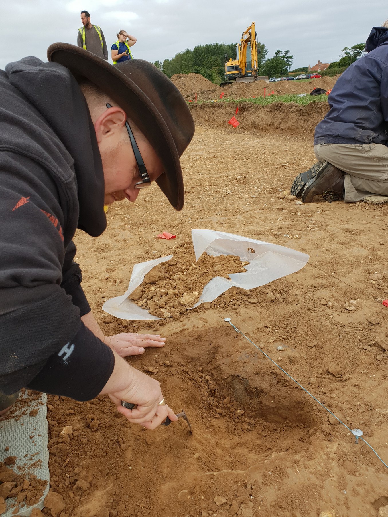 A volunteer working on the side of one of the urns