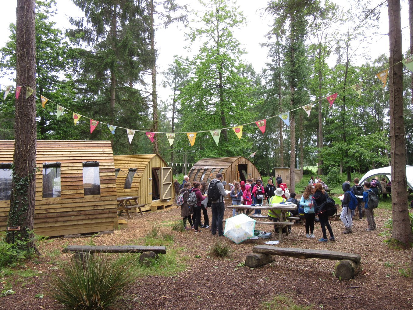 Large group of people around wood cabins