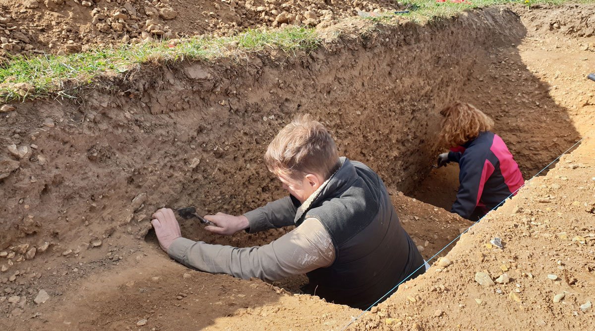 Volunteers cleaning a section through the double ring ditch. Community dig Beaulieu