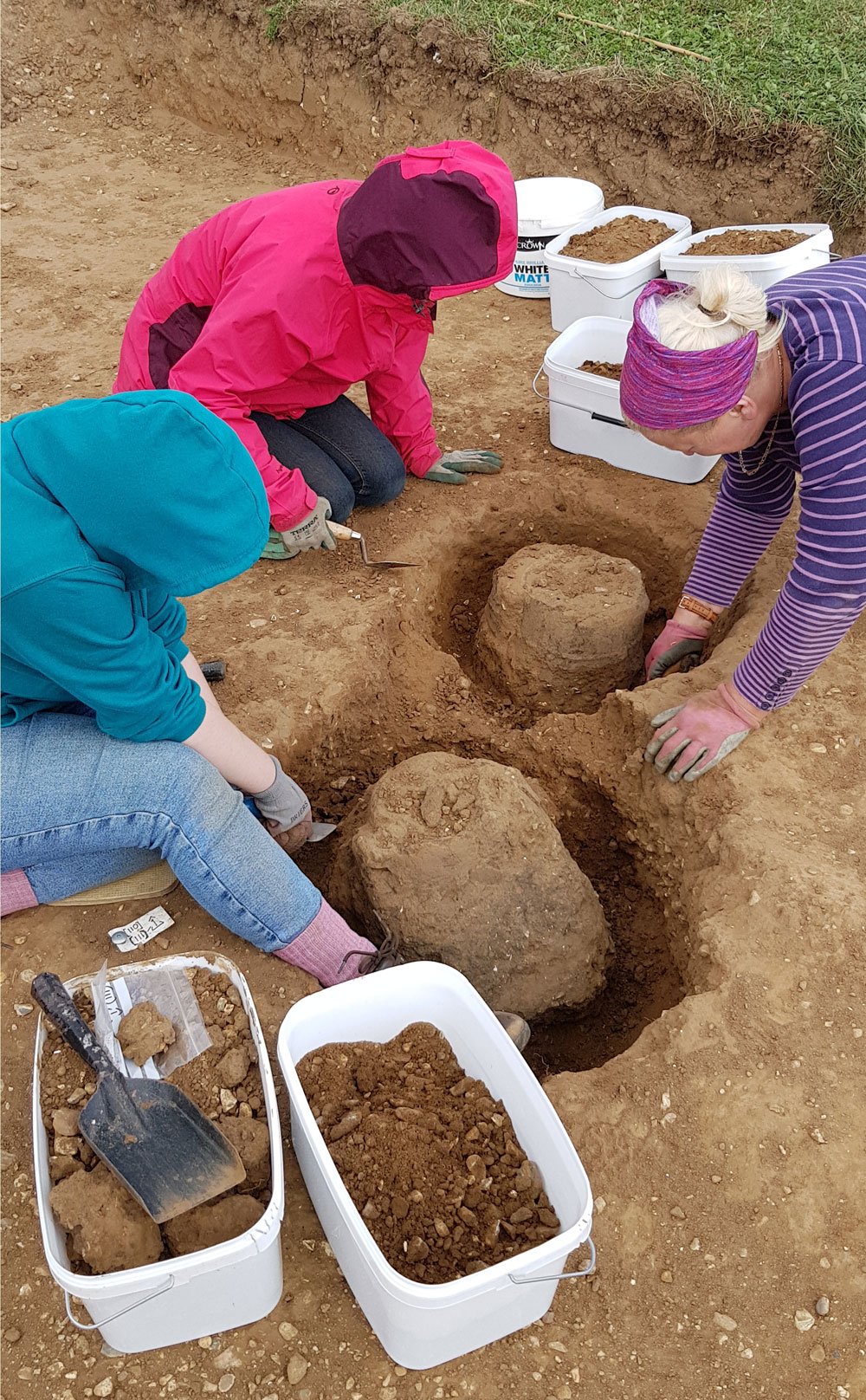 Volunteers carefully excavating Middle Bronze Age cremation urns, sampling the surrounding soil in buckets for further analysis Community dig Beaulieu