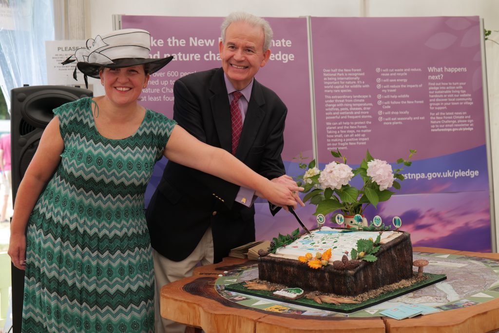 man and woman cutting cake