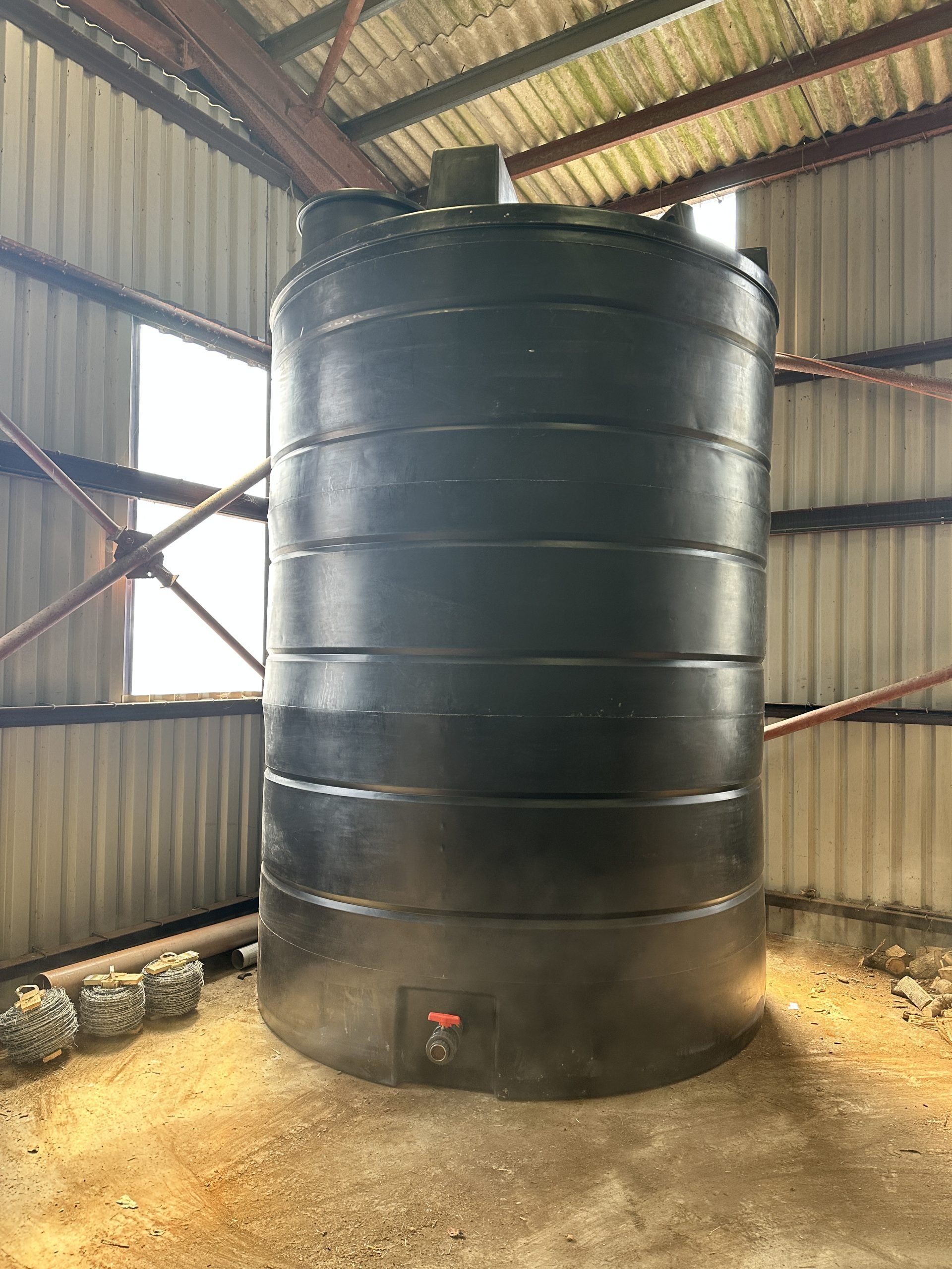 rainwater harvesting tank stored in barn