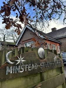 view of old Victoria school building and a sign infront of the building that says Minstead Study Centre