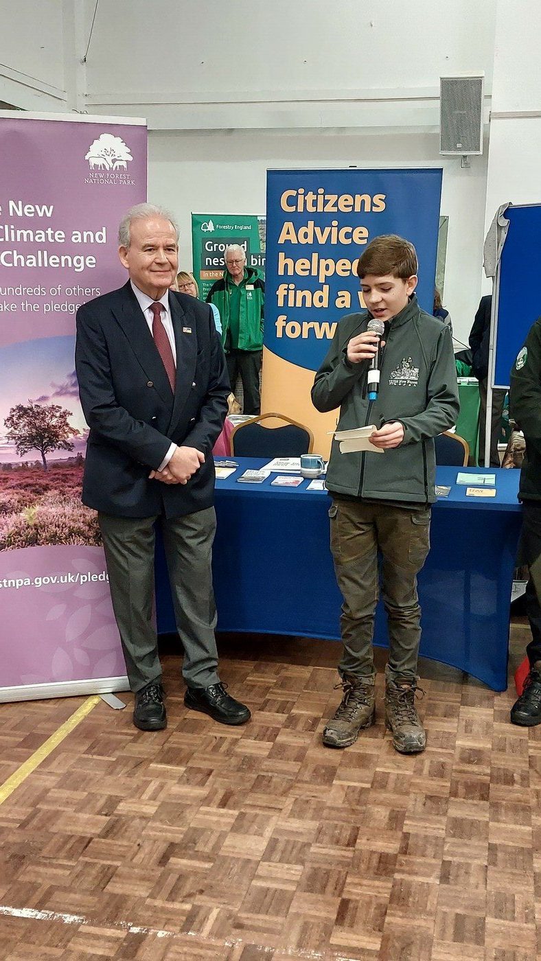 New Forest Awards Young Environmental Champion 2023, Jamie Ward speaking at the New Forest National Park Volunteer Fair alongside MP Sir Julian Lewis