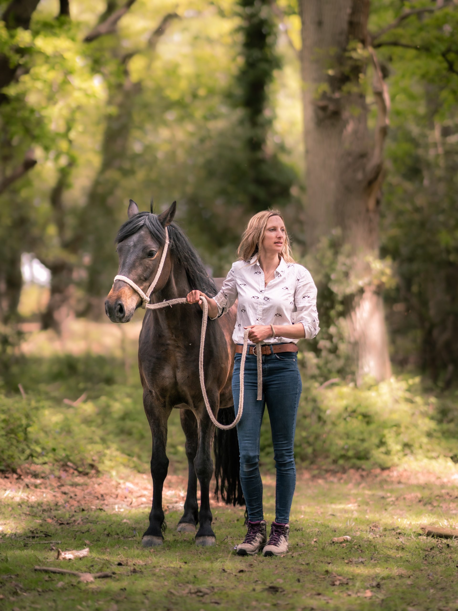 Commoner and New Forest NPA ranger Erika Dovey walking with her New Forest pony on a rein