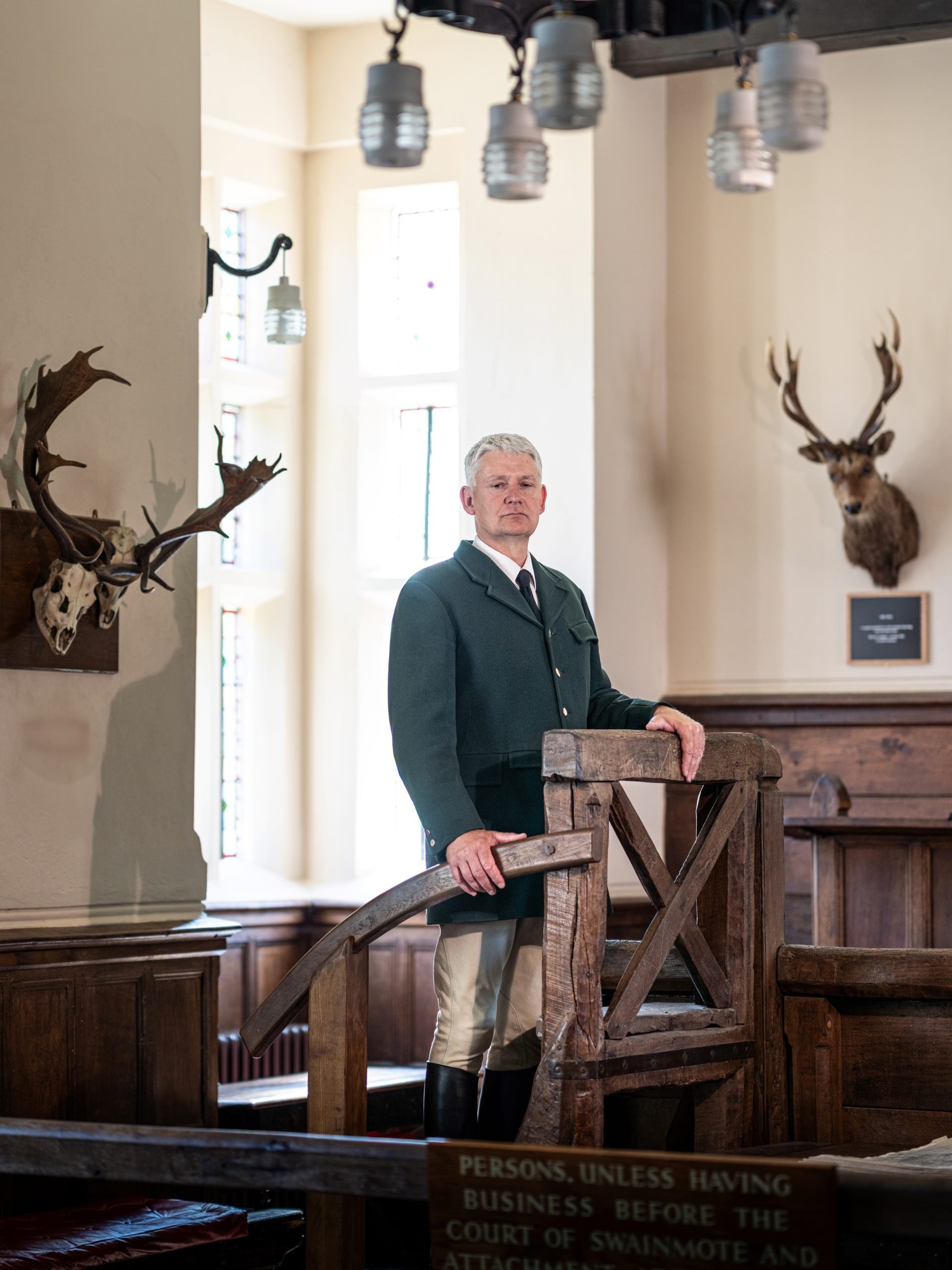 Head Agister Jonathan Gerrelli stood in the Verderers court there are mounts of stag heads and antlers on the walls