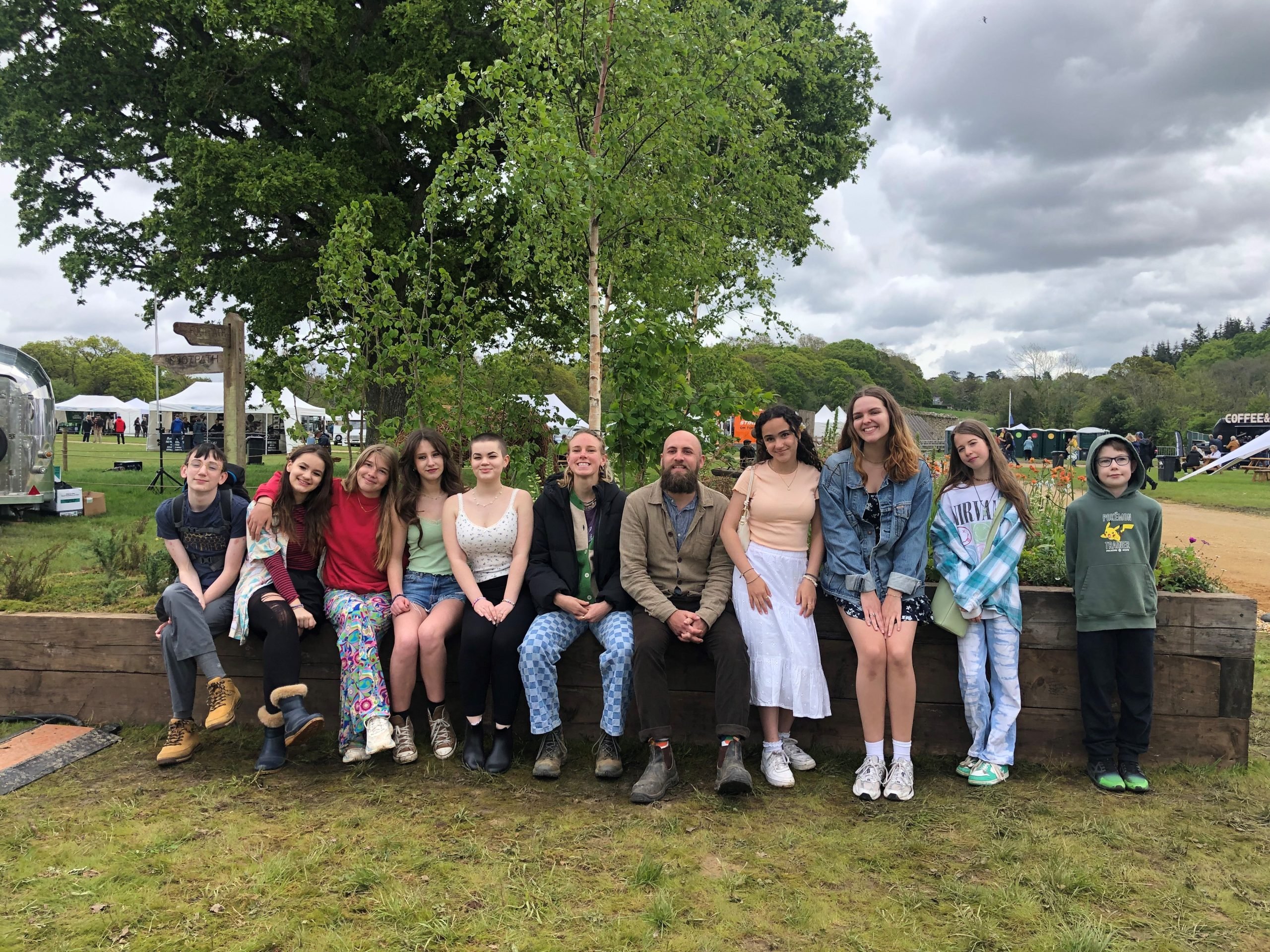 Gardeners that worked on the Forest of Calm with Leigh Johnstone aka 'The Beardy Gardener' A group of children sat by the 'Forest of Calm' community garden with Leigh Johnstone