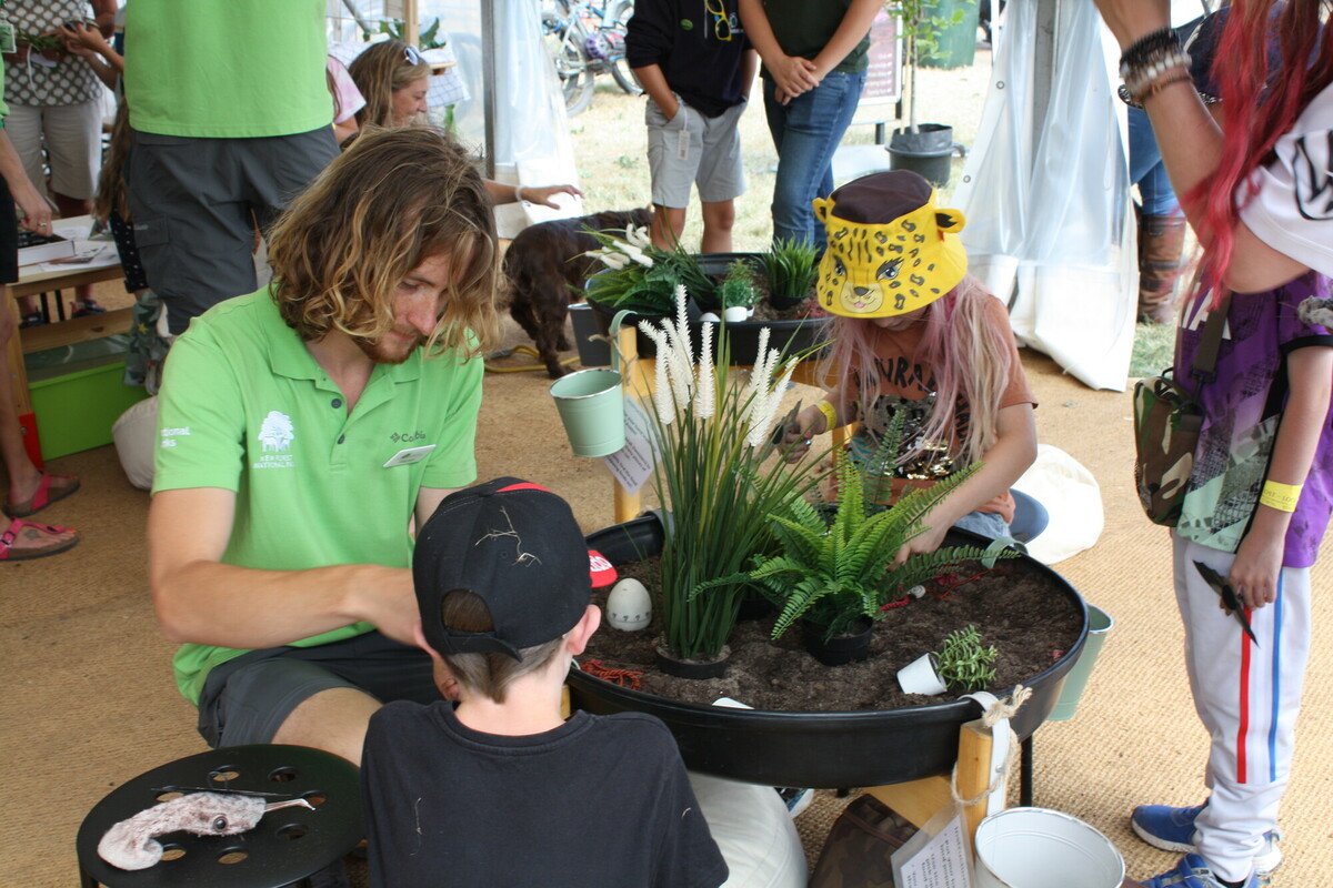 Former New Forest apprentice ranger Alistair doing a craft activity with some young children at the New Forest Show 2022