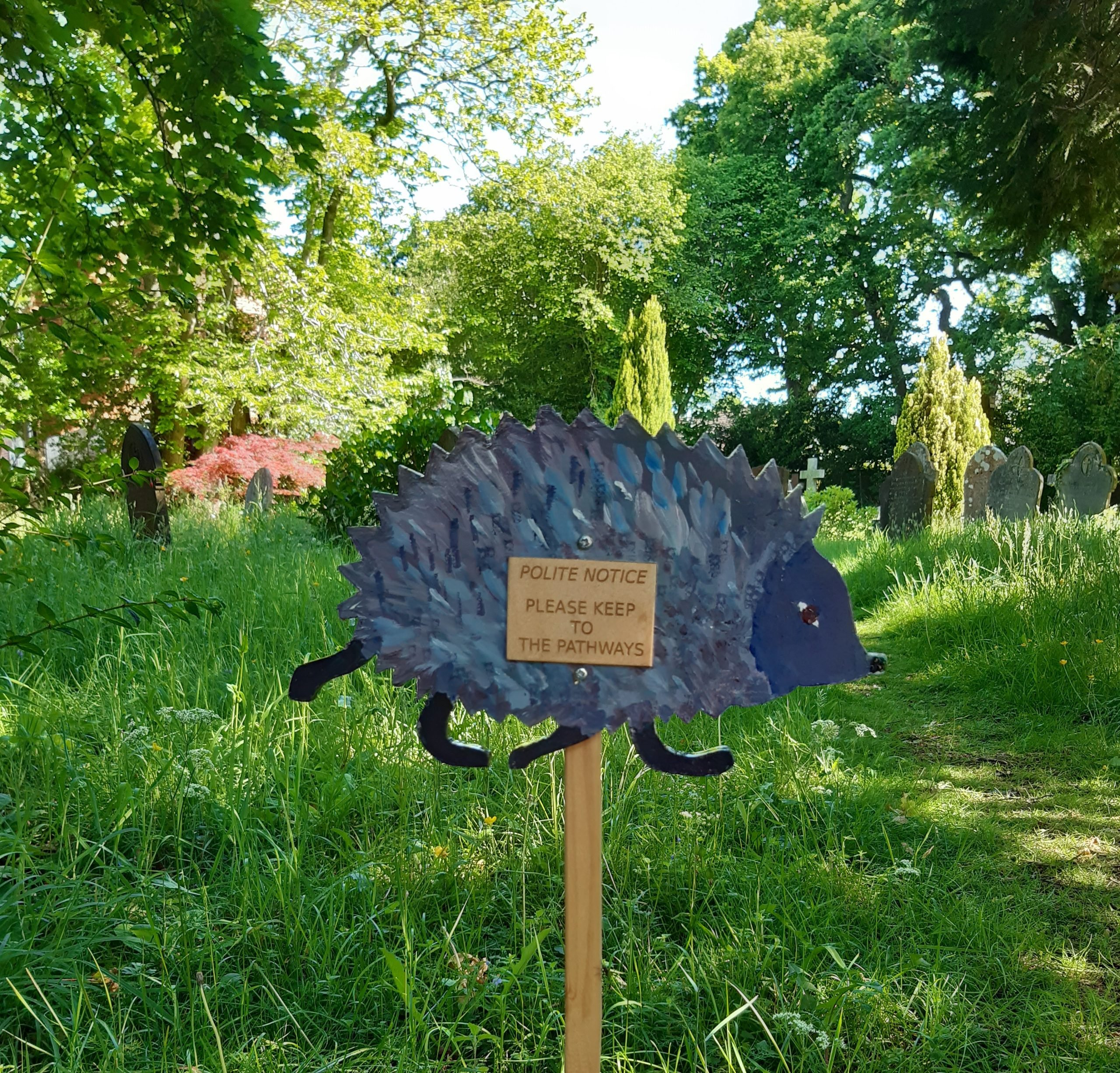 Signage created by ECO SWAY A sign shaped like a hedgehog asking people to keep to the path
