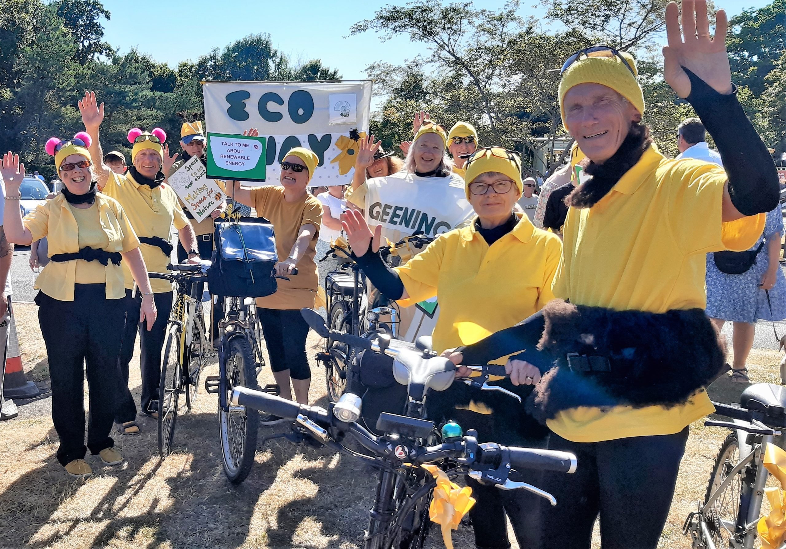 ECO SWAY at a cycling event Eco Sway volunteers with yellow tops, bikes and banners