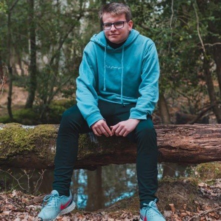 New Forest Youth Board member Toby sitting on a log