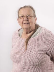 head & shoulders of a woman in a pink jumper