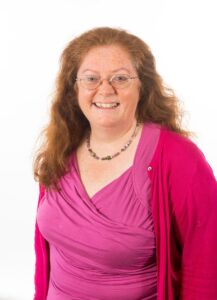 head & shoulders of a woman in a pink top