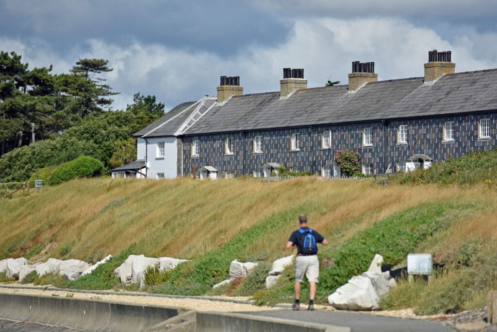 a man walking past a row of houses
