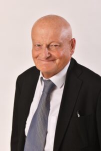 head & shoulders a man in a navy jacket and grey tie