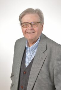 head & shoulders of a man in a grey jacket and waistcoat