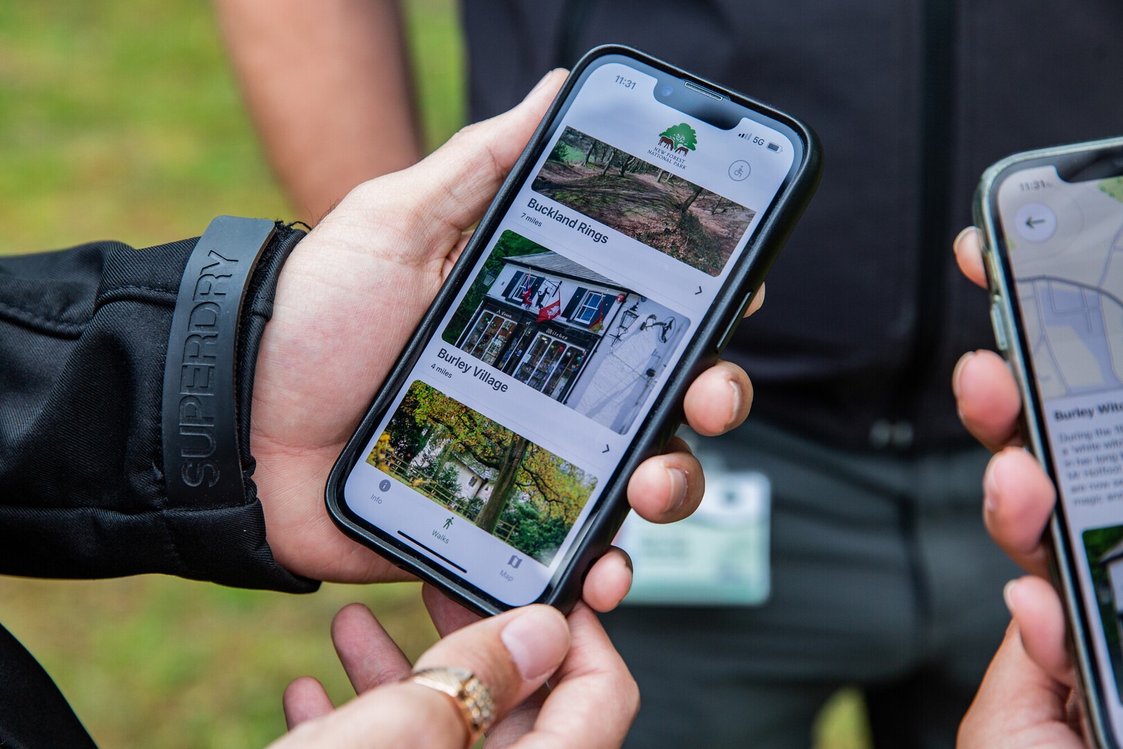 a close up of a hand holding a mobile phone with an app showing walks