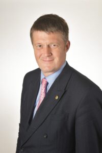 head and shoulders of a man in a suit and tie