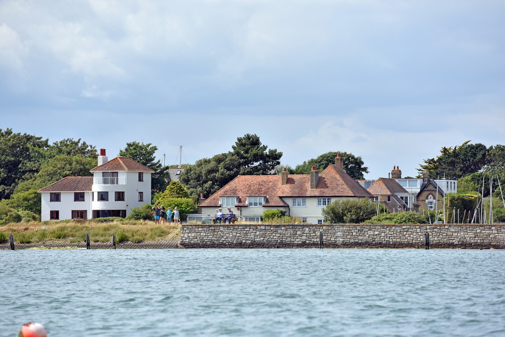 houses behind a wall at the beach