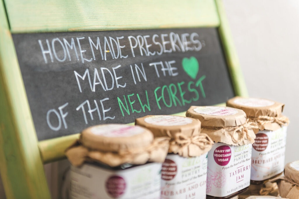 Jars of pickles with a sign saying homemade preserves in the New Forest