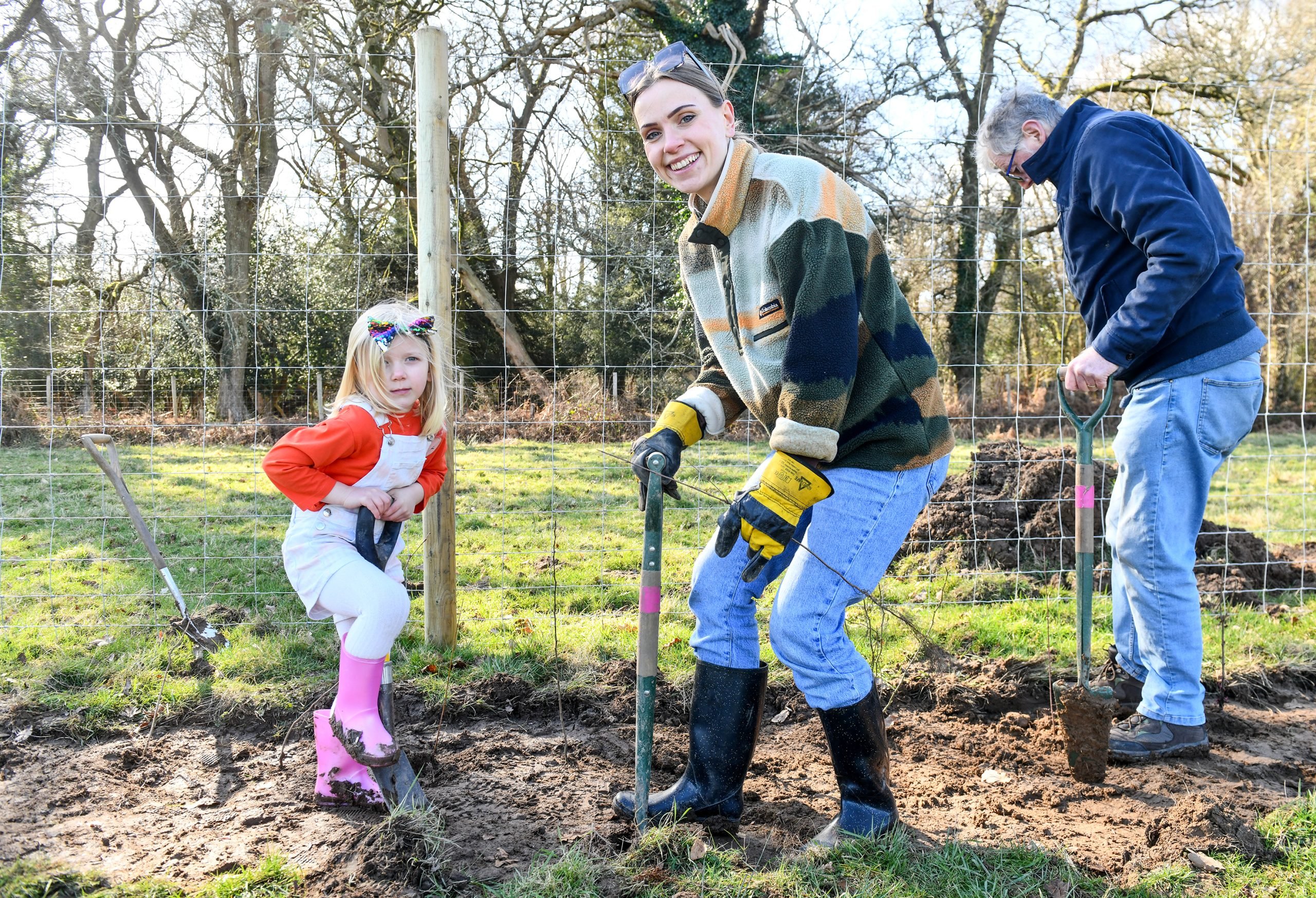 A person and child planting trees