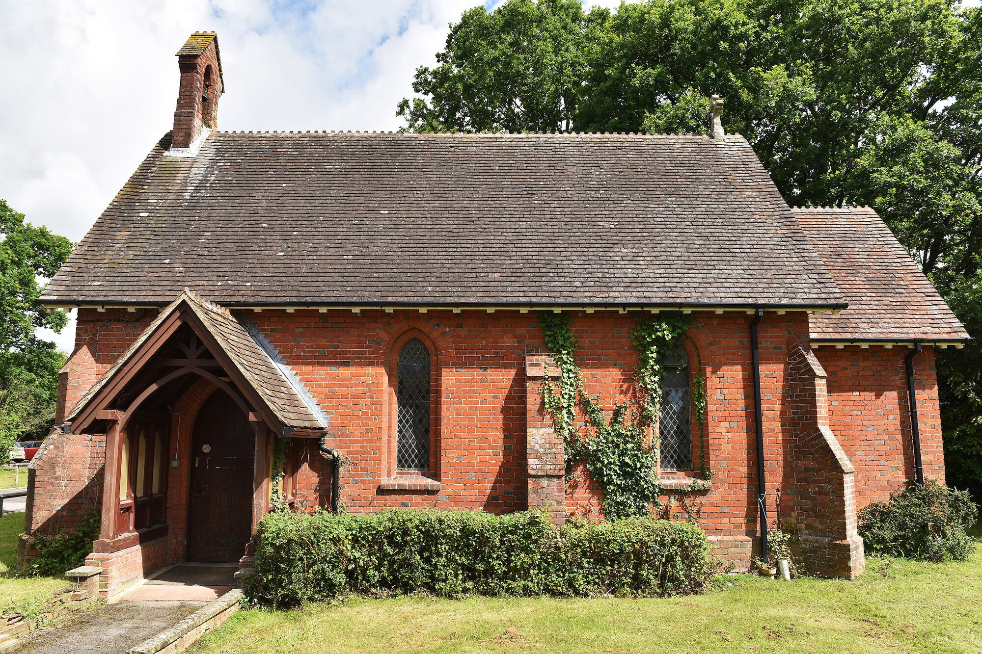 A brick chapel with porch and bell tower
