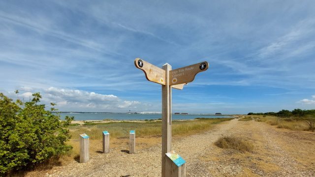 a footpath signpost on a gravel track