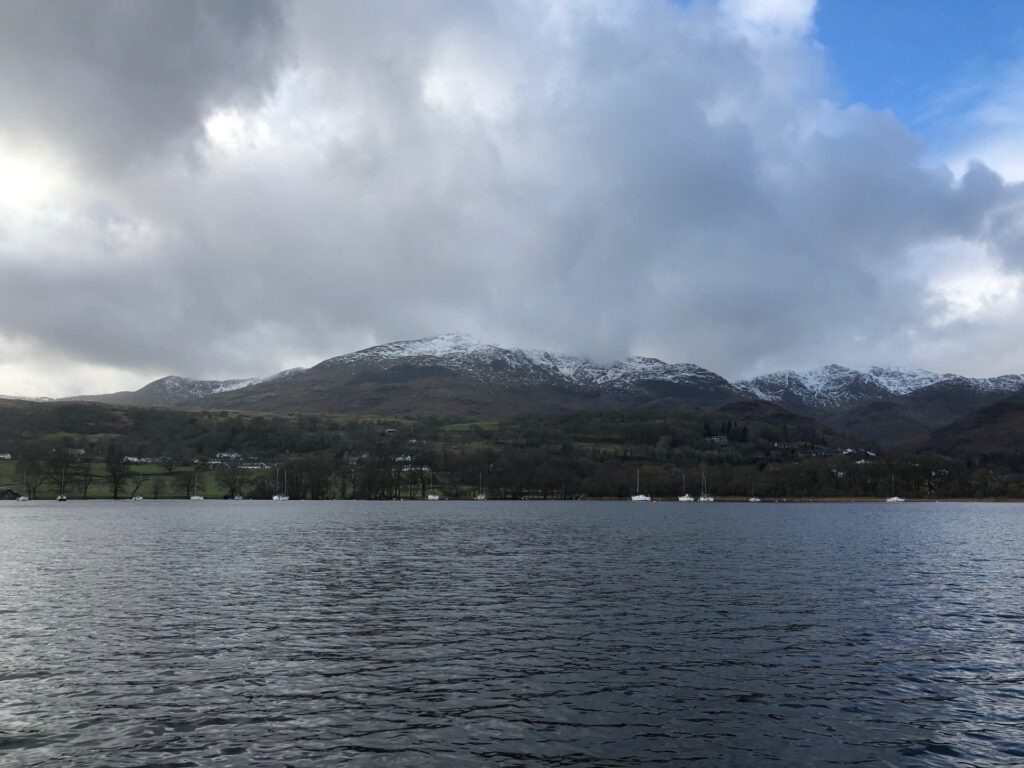 a lake with snowy mountains behind