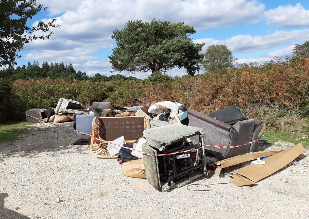 fly tipped waste on a gravel car park in the countryside