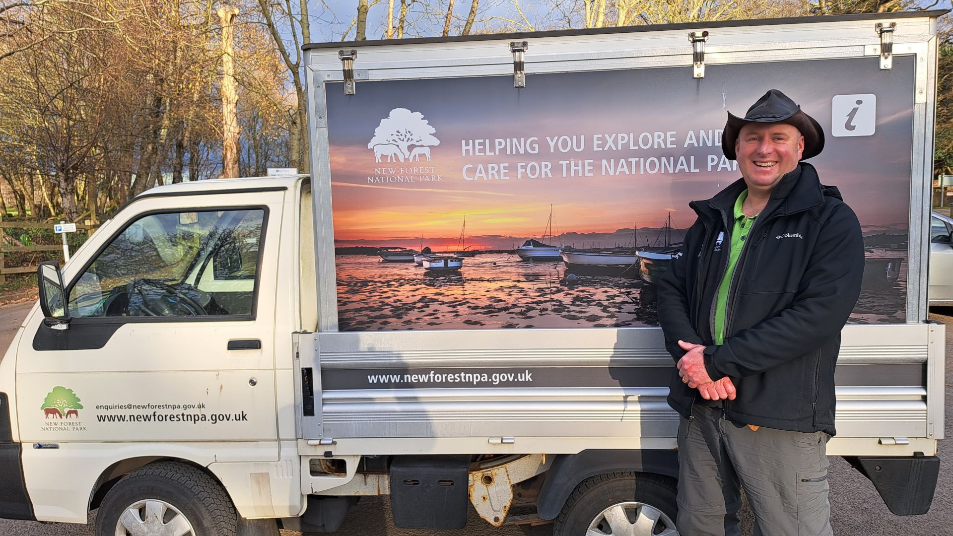 a ranger standing in front of an information van