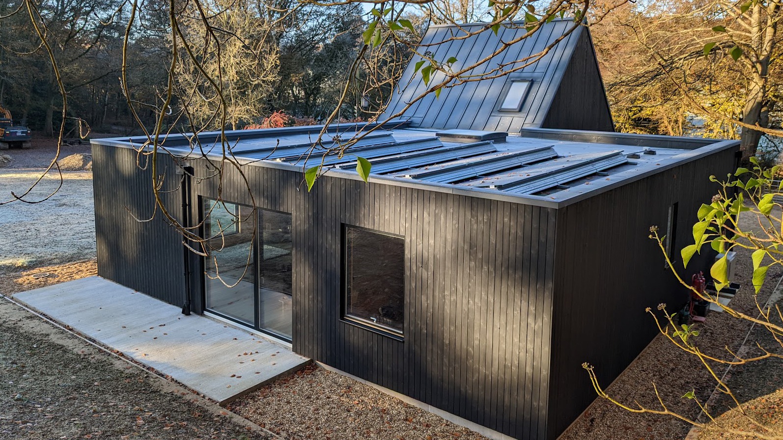 Dark-clad modern house in a woodland setting