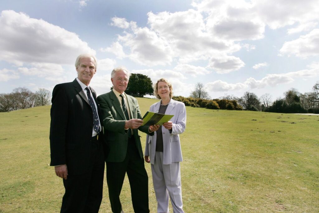 three people standing in a field