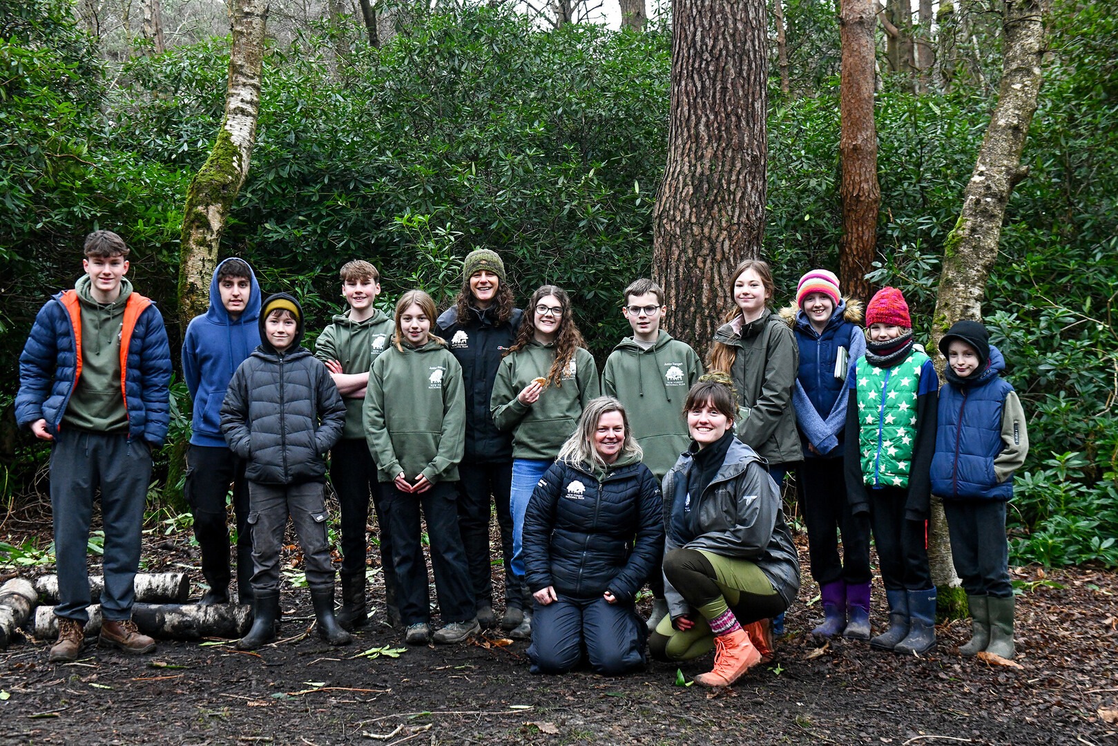 A group of New Forest Junior Rangers and New Forest NPA staff in a wooded area