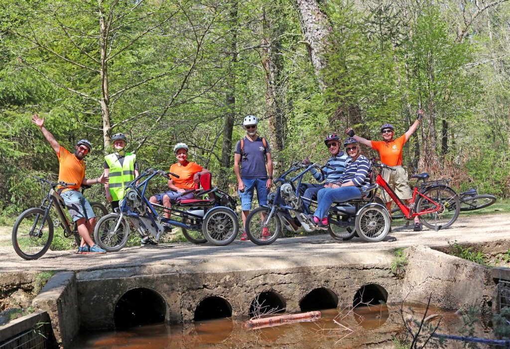 a group of people sitting on bikes on a bridge