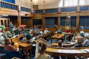 A council chamber full of people dressed as animals