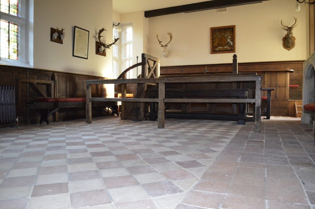 an old court room with wood panelling and stag heads on the wall
