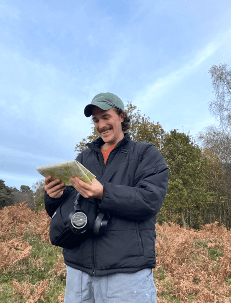man looking down at a map and smiling