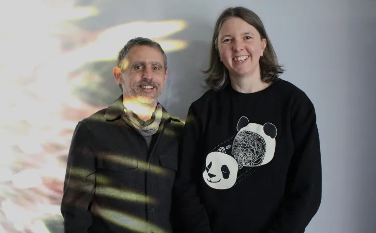 man and a woman smiling at the camera
