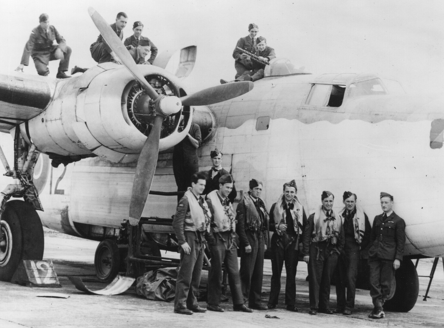 No. 311 Czechoslovak Squadron airmen posing on and beside a Liberator bomber at Beaulieu airfield, 1943