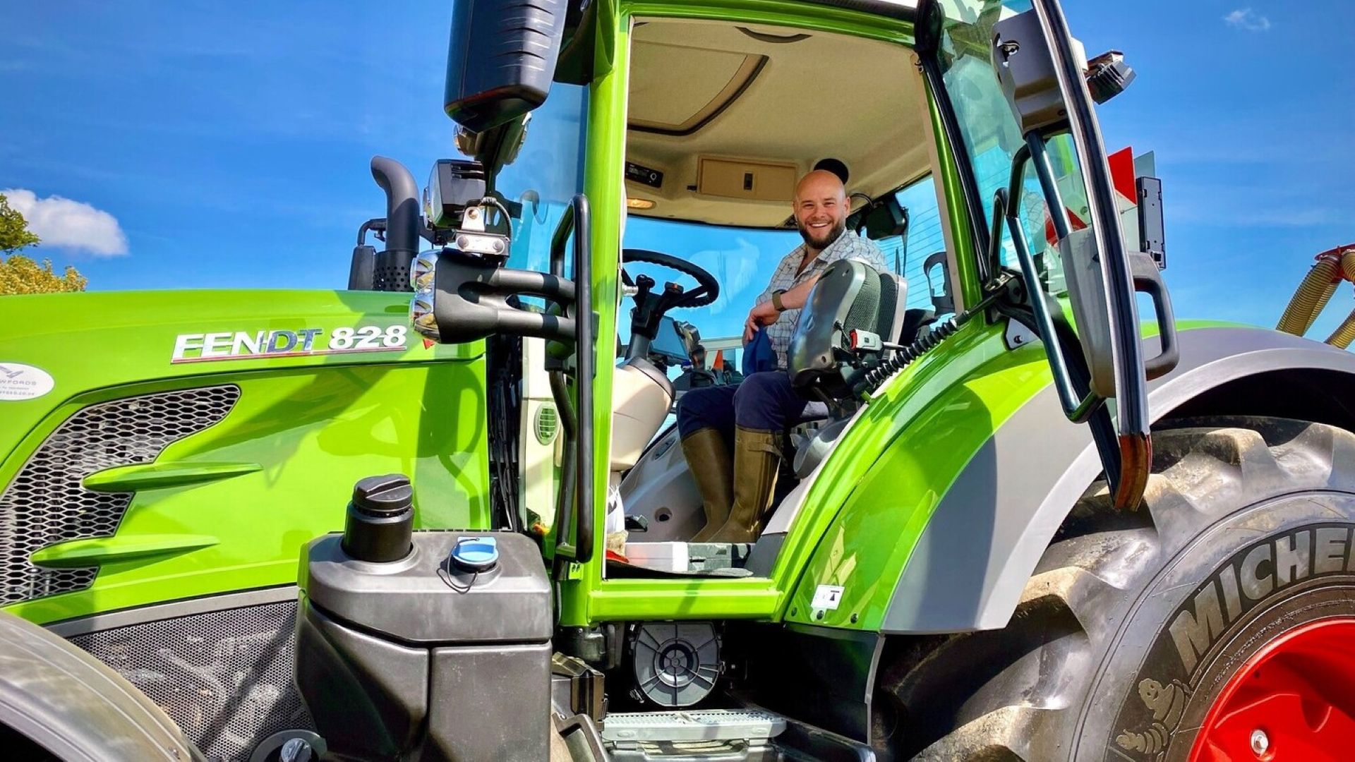 A person sitting in a green tractor