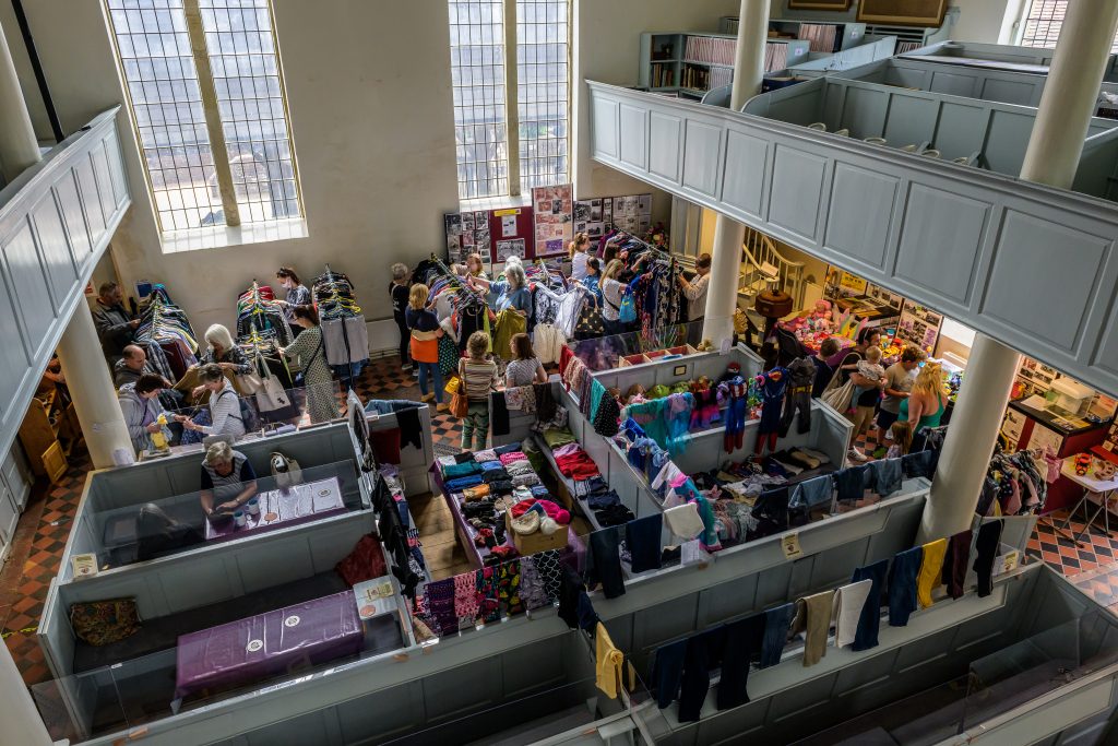A fair with people looking at different stalls