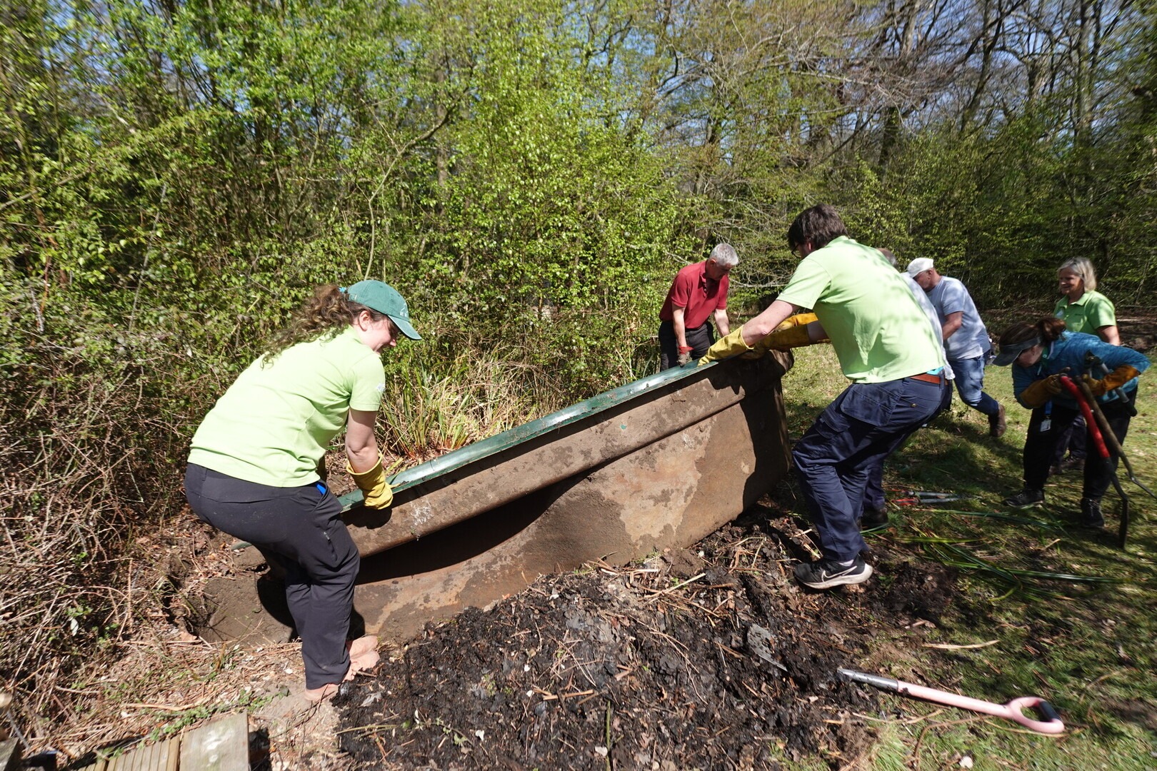A team of volunteers work together on a conservation task.