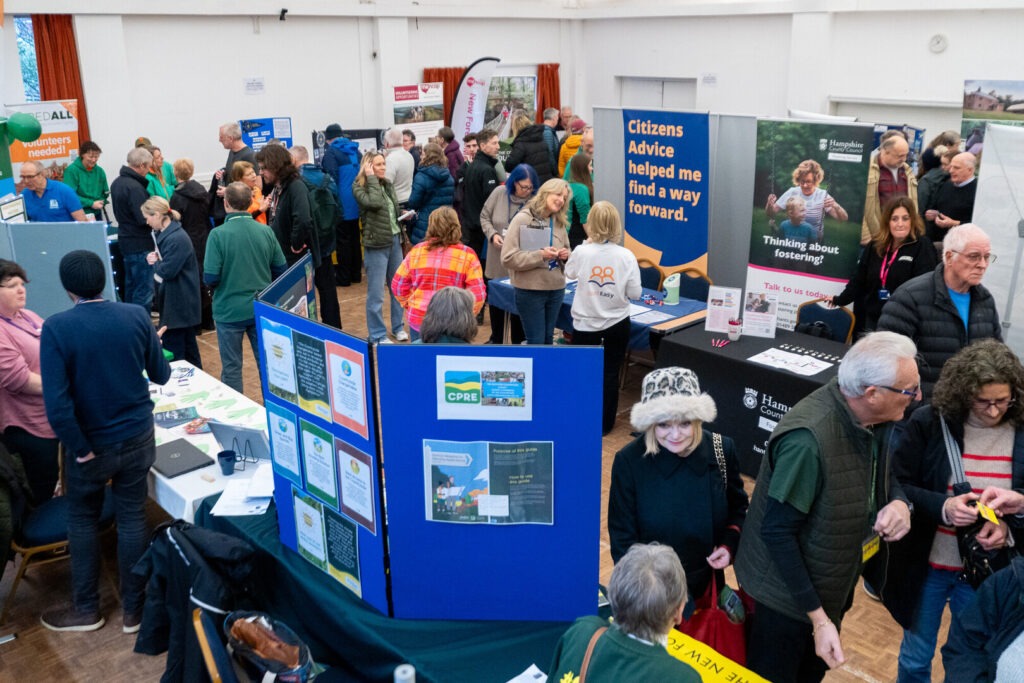 People in a crowded hall at the New Forest National Park Volunteer Fair.