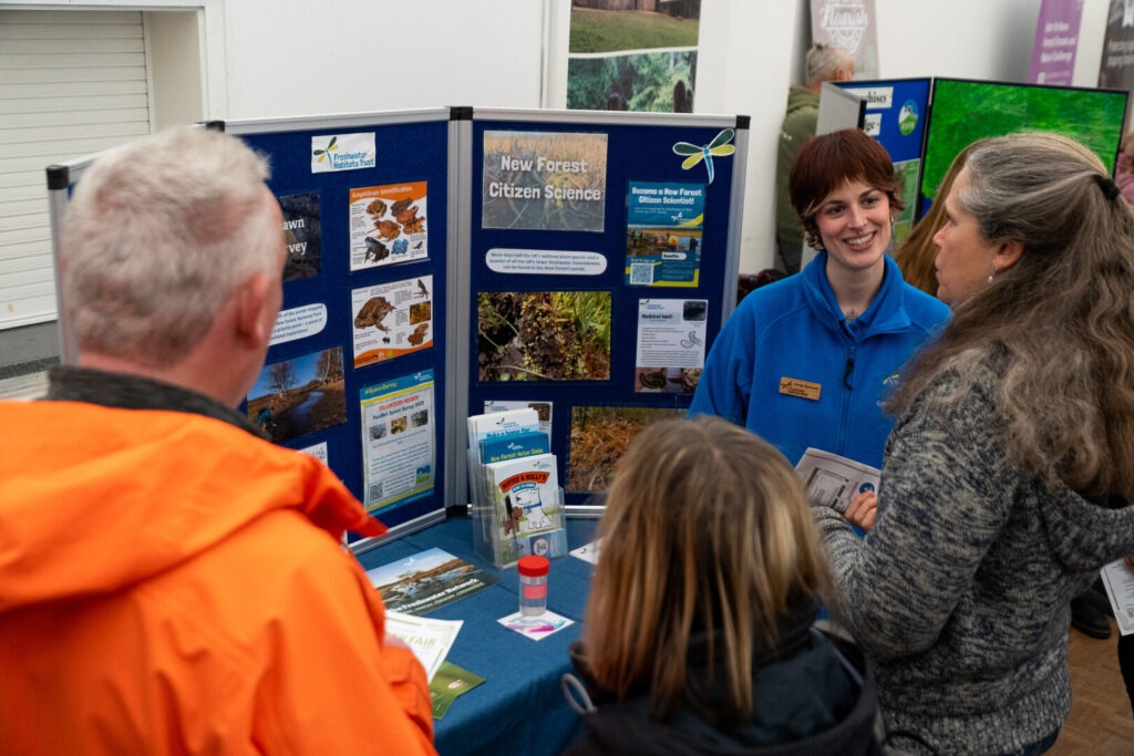People interested in volunteering in the New Forest speak to NPA partner, Freshwater Habitats Trust at the 2026 New Forest National Park Volunteer Fair