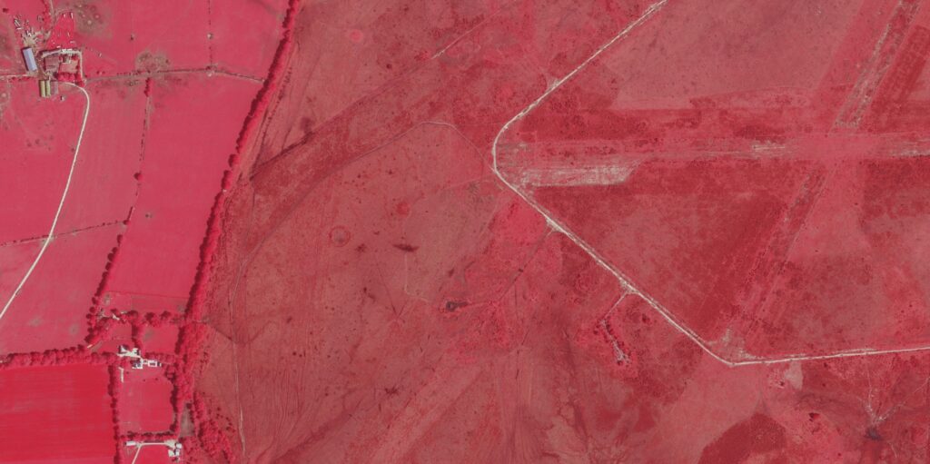 Near infrared aerial view of Beaulieu Enclosure showing fields, tracks, and faint circular barrow and enclosure earthworks in heathland