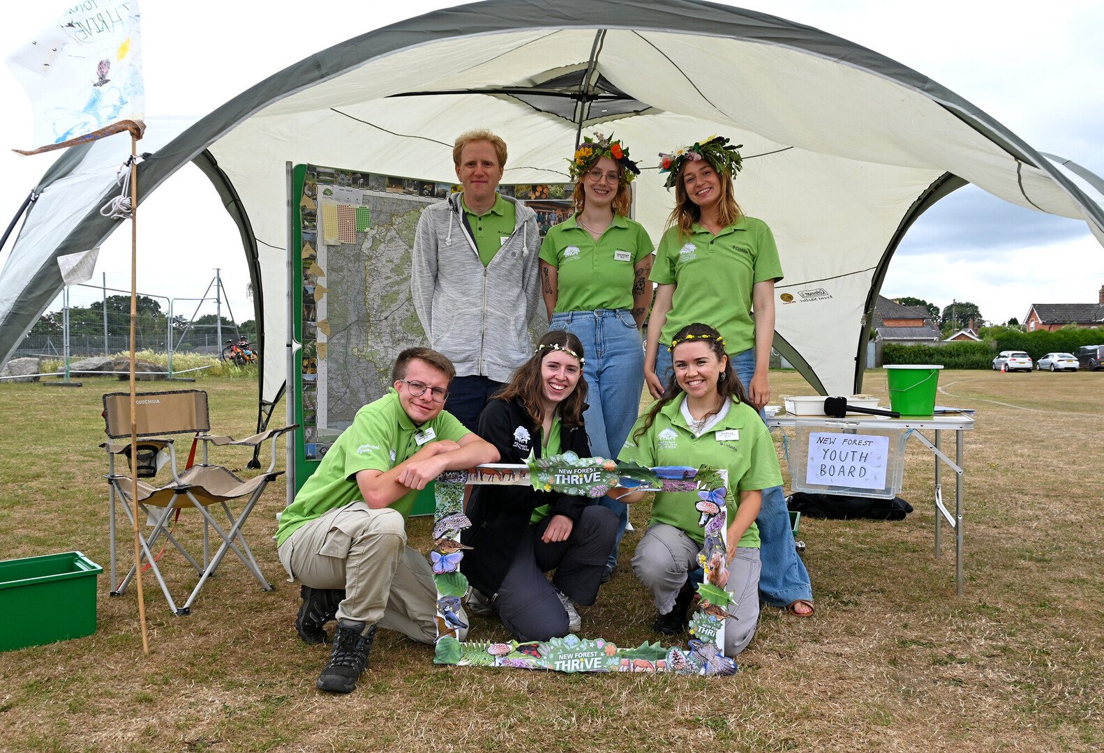 The New Forest Youth Board at New Forest Thrive festival in Ringwood 2025 stand in a group in a tent.