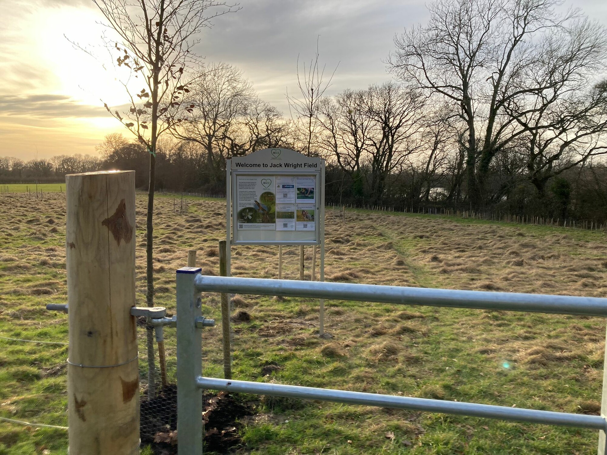field with a gate and sign