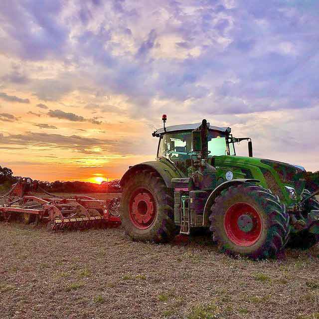 Tractor in a field at dusk
